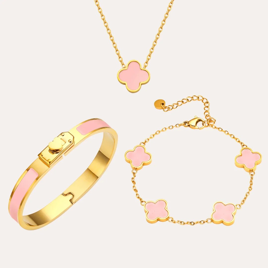 Kleeblatt Layering Ketten Trio aus Edelstahl in Goldfarben mit rosa Kleeblatt-Anhängern